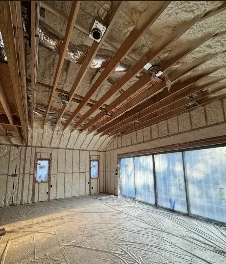 Interior walls and ceiling insulated with spray foam during new construction in Kimball